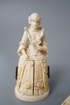 A pair of 19th century ivory balm pots, 3.75cm., a smallDieppe triptych figure, 6.5cm. a Meiji tiger brooch and a Dutch page marker.